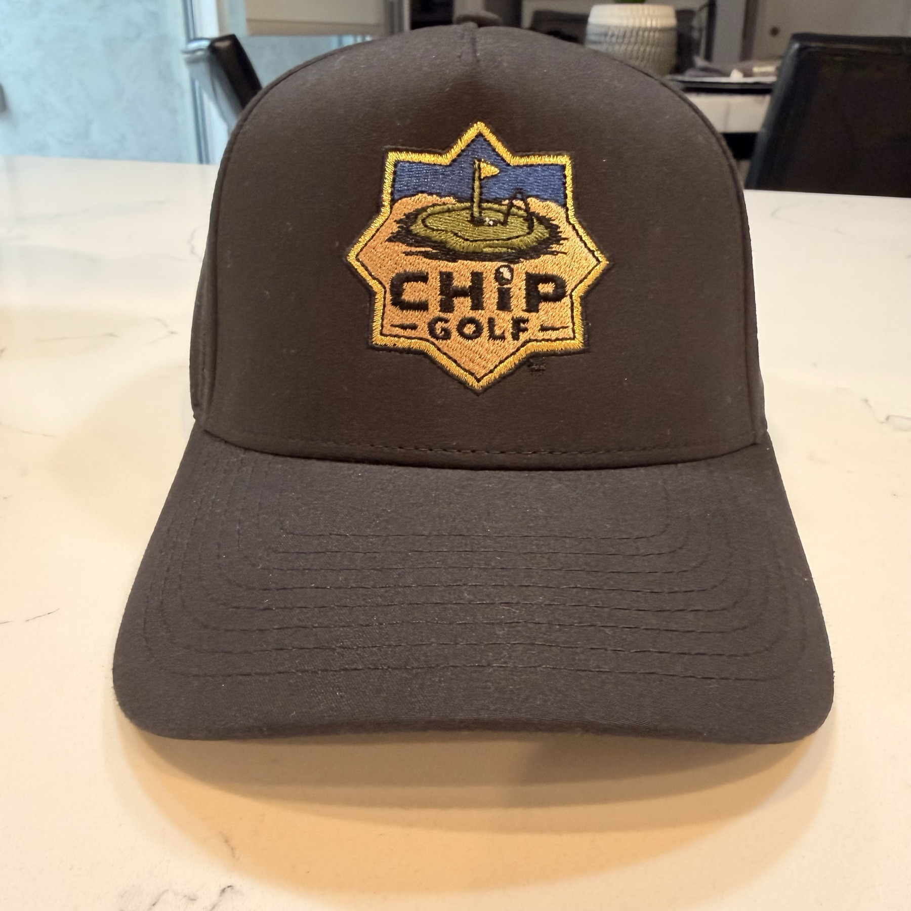 The Crest Cap in black, front view